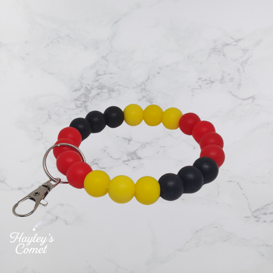 Colorful beaded keychain with silver clasp on a marble background with 'Hayley's Comet' branding.